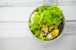 Fresh lettuce salad with yam and boiled egg with salad dressing.
