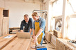 © Cavan Images - Mid adult men working in carpentry workshop