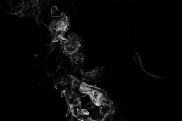 Smoke the white incense on a black background. darkness concept