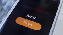 Smartphone with Alarm Clock on Display. shake on table