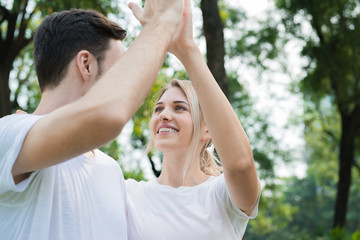 A beautiful girl giving high five energetic with her boy friends