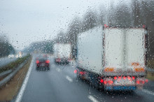 Traffic in the rain viewed from a buss as blurred image
