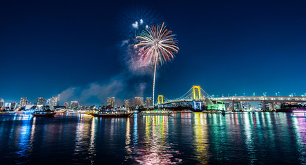 city skyline view of tokyo bay, firework, rainbow bridge