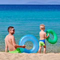 Toddler boy on beach with father