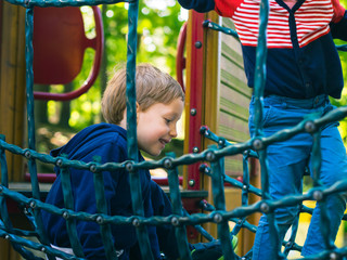 Little boy playing on a playground. Activity