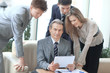 © yurolaitsalbert - businessman and his colleagues sitting at the table in the office