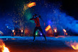 © Andriy Medvediuk - Fire show, dancing with flame, male master juggling with fireworks, performance outdoors, draws a fiery figure in the dark, bright sparks in the night.