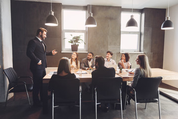 Poster - Corporate business team discussing project plans in office