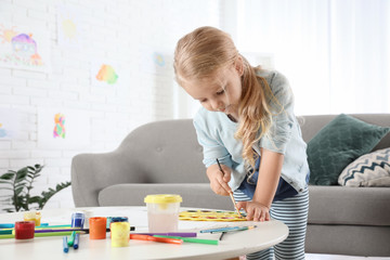 Poster - Cute little child painting at table indoors