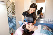 © Alexander - Professional beautician doing eyebrow tattoo at woman face. Permanent brow makeup in beauty salon, closeup. Cosmetology treatment