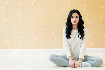 Wall Mural - Portrait of a young woman on a shiny light background