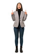 © luismolinero - A full-length shot of a Young business woman pointing up and surprised over isolated white background