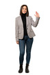 © luismolinero - A full-length shot of a Young business woman saluting with hand with happy expression over isolated white background