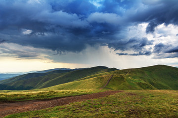 Summer in the Carpathian massif of Swidovets, located in Ukraine, with a lot of lakes, green pasture for sheep and horses, and wonderful, after a stormy sky with a rainbow.