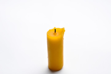 Yellow candle isolated on a white background