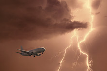 Passenger Airplane Landing In The Stormy Weather On The Backdrop Lightning