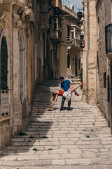 Man holding woman on hands on the street