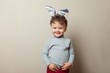 © tumskaia - Cute little boy with bunny ears on grey background