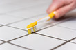 cleaning tiles with a toothbrush