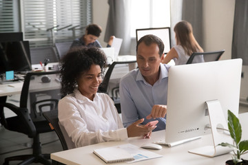 Multiracial colleagues communicate sitting in the office