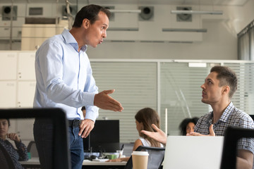 angry millennial colleagues arguing in office workplace