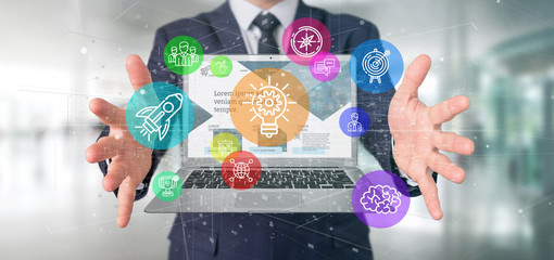 Poster - businessman holding a cloud of colorfull start up icon bubble with a laptop 3d rendering