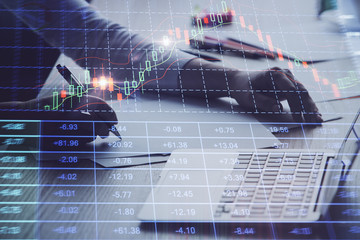 Poster - Close up of hands writing with double exposure of business charts. Financial concept.