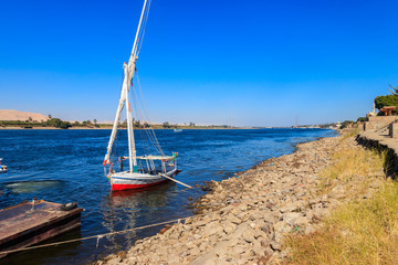 Felucca boat moored near the shore of Nile river in Luxor, Egypt