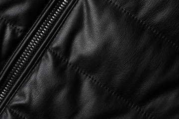 Black leather texture closeup as background. Jacket leather fabric texture.