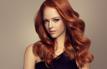 Beautiful Model  Girl With Long Curly Red Hair .  Styling Hairstyles Curls .Wavy Shiny Hair