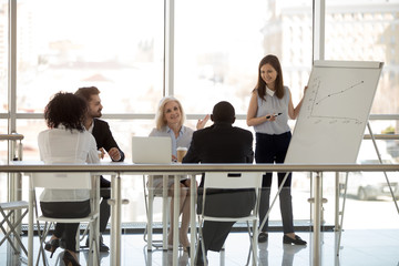 Wall Mural - Diverse businesspeople sitting in boardroom discussing listening young coach