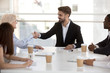 © fizkes - Businesswoman shaking hands with company client at meeting in office