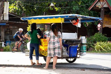 Thai women buy food form local vendor cart and sidecar beside road in morning time at Ban Phe beach in Rayong, Thailand