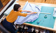 © JackF - High angle view of female seller measuring textile