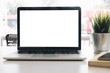© wichayada - Mockup blank screen laptop on desk in office room background.