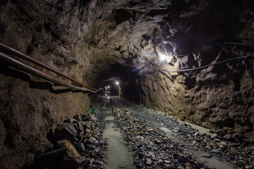 Underground gold ore mine shaft tunnel gallery passage with light