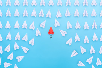 Canvas Print - Business competition, successful businessman concept with Red paper plane flying overtake the other white paper planes on blue background.