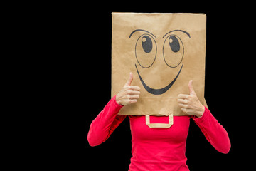 Woman wearing paper bag with happy face on black