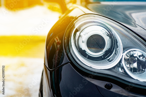 The image in front of the dirt black car scene behind as the sun going up Obraz na płótnie