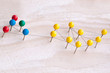 © Natalya Lys - Communication concept inside a group of people. Family, work, business, network connections. Needles with colored heads and threads between them.