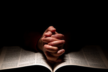 Wall Mural - Person Praying with Hands on Top of the Bible