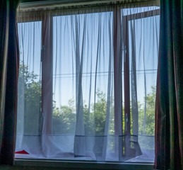  Window view witha net curtain and difussed view of the outside.
