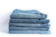 © Atlas - Stack of blue jeans on white background, space for text