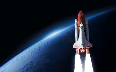 Leinwandbilder - Space shuttle in the space near Earth planet. Black background. Atmosphere. Elements of this image furnished by NASA