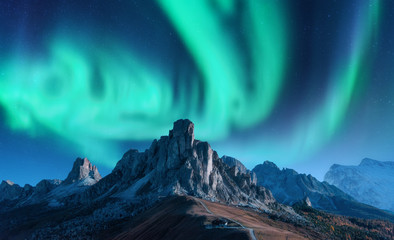 Wall Mural - aurora borealis above mountains at night in europe. northern lights. sky with stars with polar light