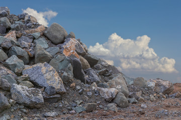 Wall Mural - Many granite piles with sky clouds.