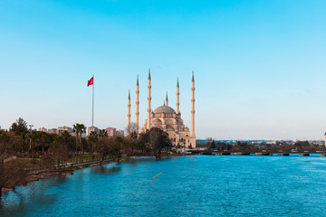 Wall Mural - Sabanci Central Mosque in Adana with Seyhan River and Trees. Mosque has reflections from Seyhan river in sunny day with blue clean sky