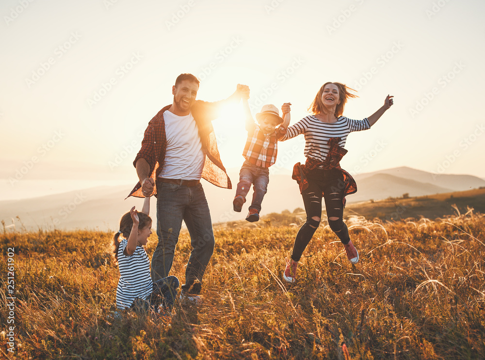 Happy family: mother, father, children son and daughter on sunset. - obrazy, fototapety, plakaty 