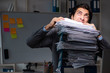 © Elnur - Young male employee working late at office