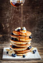 Pancakes With Banana, Blueberry And Maple Syrup For A Breakfast.